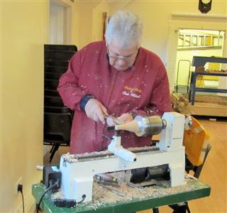 Chris turning a bird to go on another tree decoration